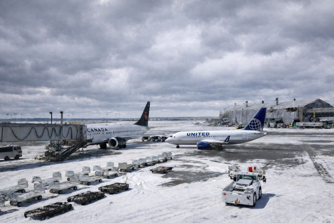 Airplanes parked at Calgary International Airport in winter, arrival point for visitors joining Banff National Park Tours in Alberta Canada
